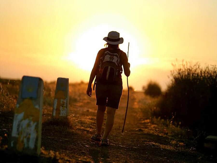 walking alone into the sunset with the arrow on the marker