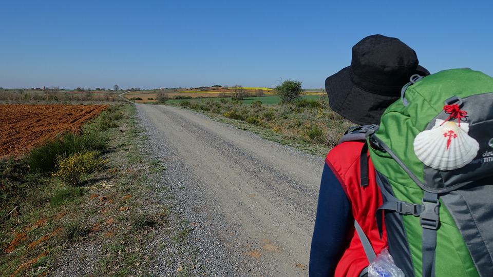 Pilgrim with the scallop shell on the large backpack