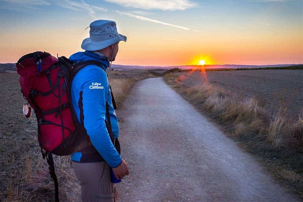 A man looking at the sunset on the camino route in France