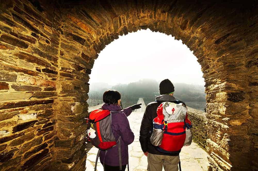 Romantic couple on the camino de santiago under the arch