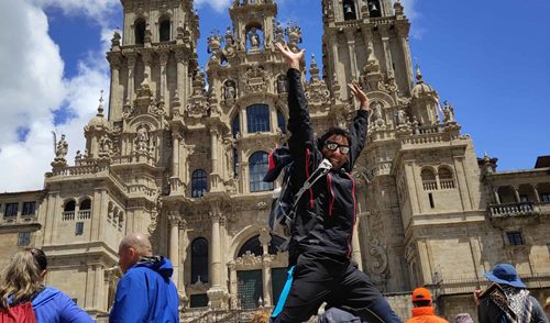 student joy with joy in front of santiago de compostea cathedral