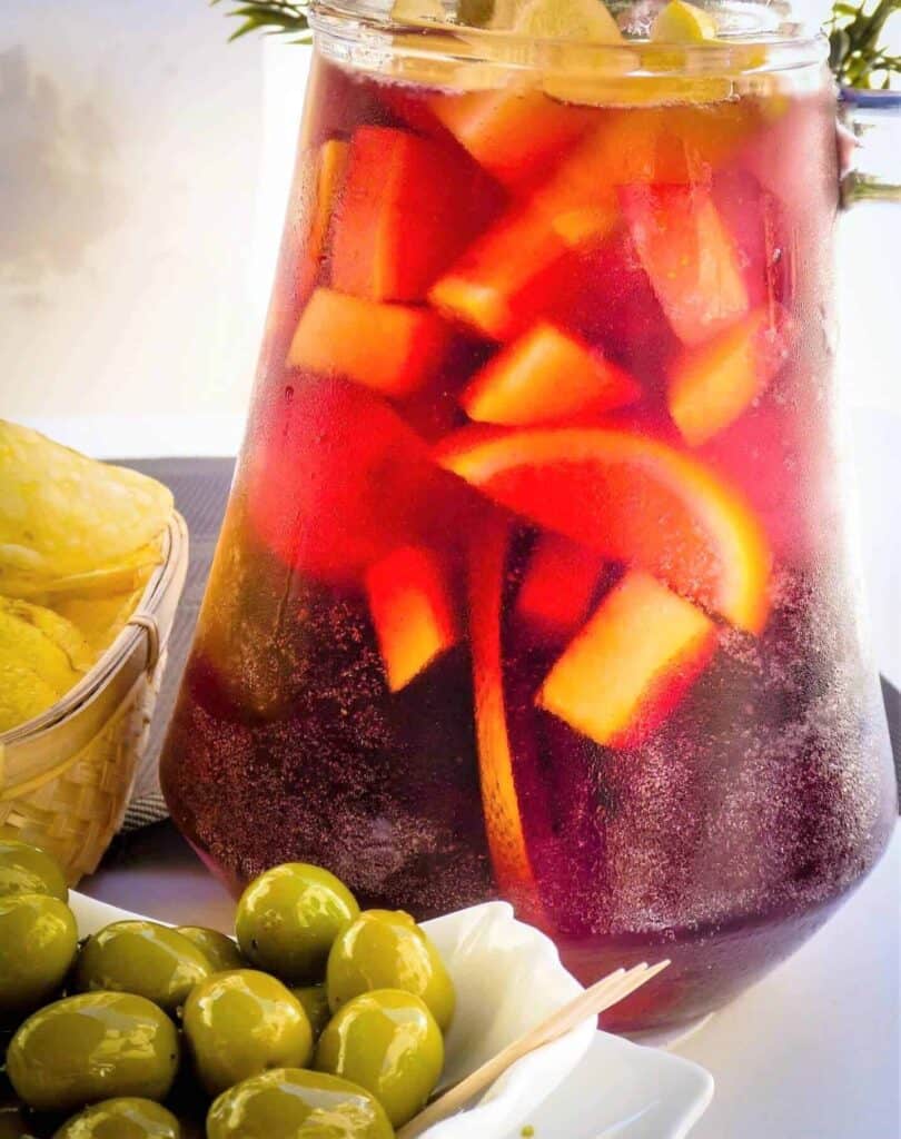 pitcher of spanish sangria with olives and tapas