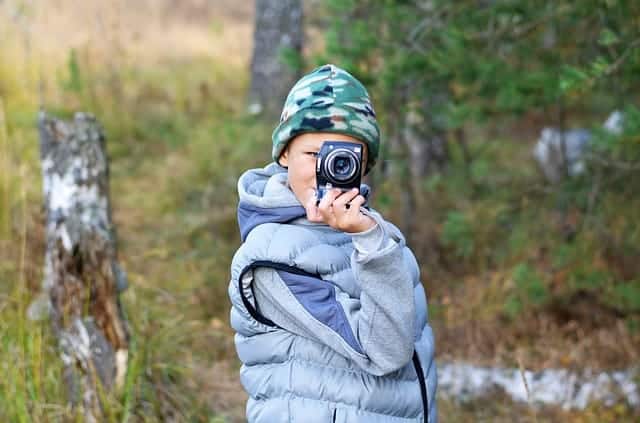 child taking photo on holiday