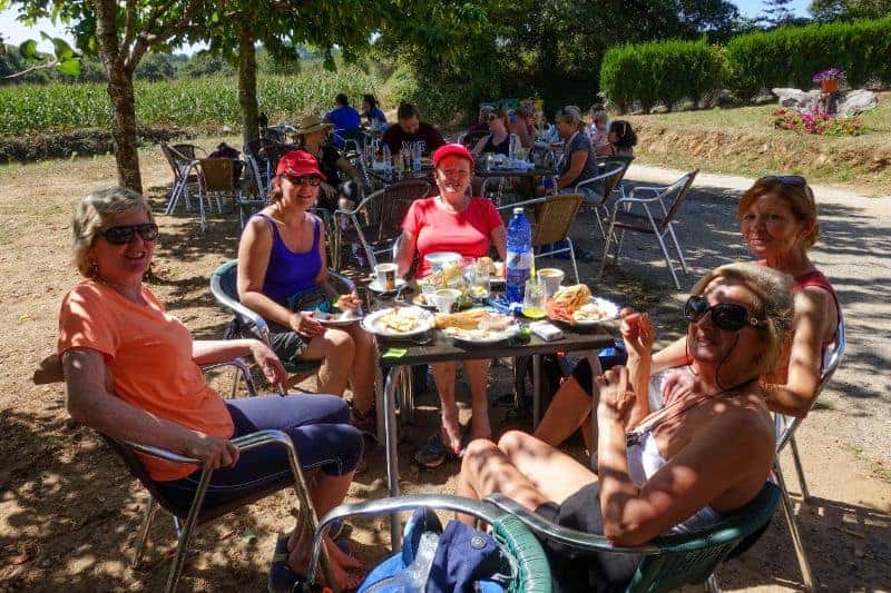 group of pilgrims taking a break for lunch at a cafe on the way of st james