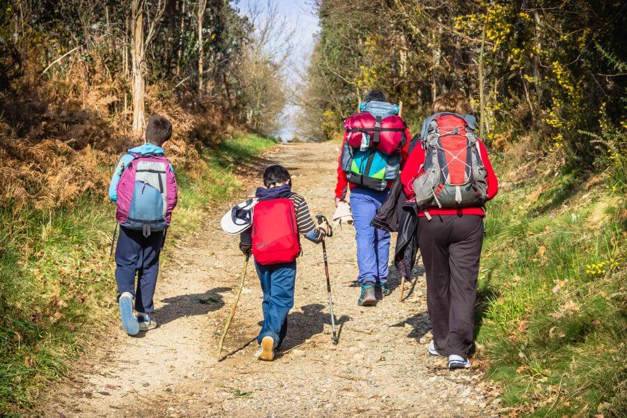 Pilgrims with kids walking outside Labacolla