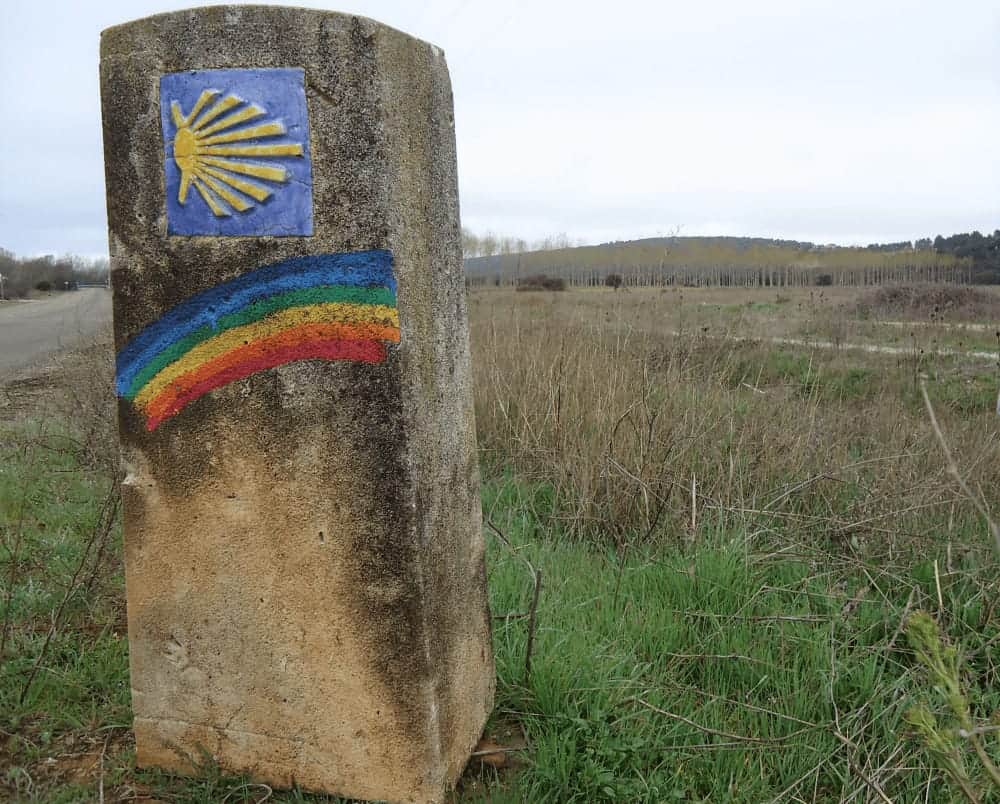 rainbow on a camino marker