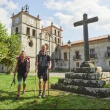 a picture of 2 pilgrims walking in front of a church