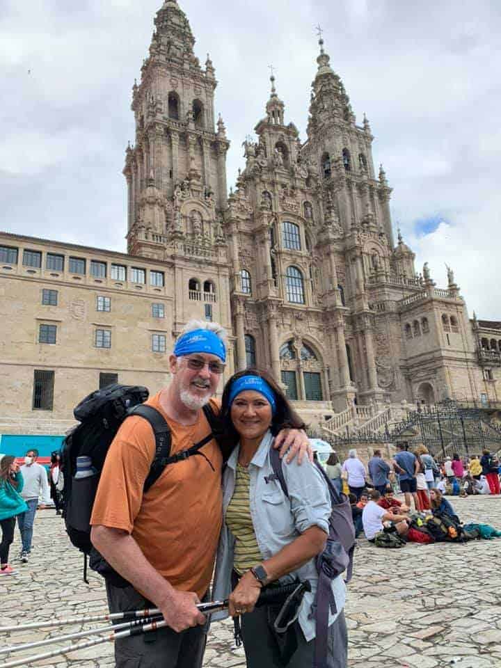 a picture of 2 pilgrims standing in front of a cathedral