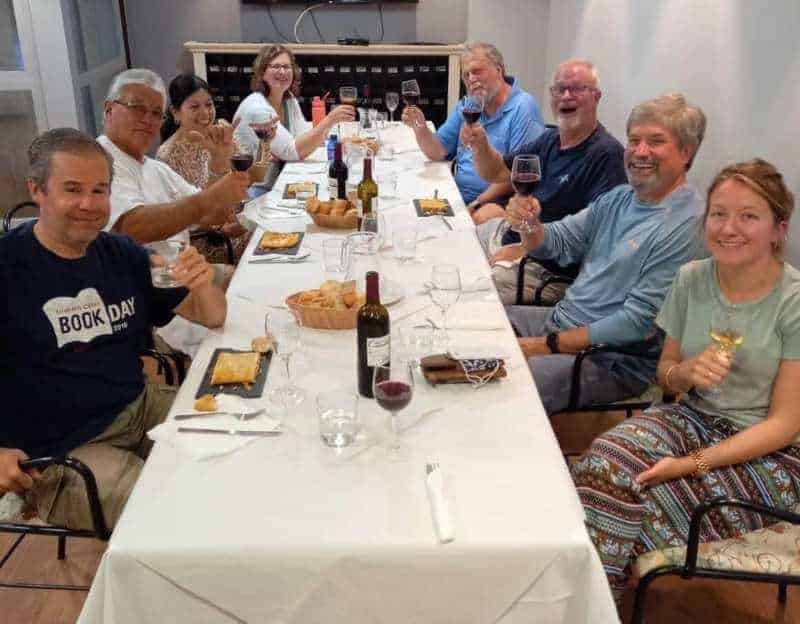 a picture of a group of pilgrims having a dinner on the Camino