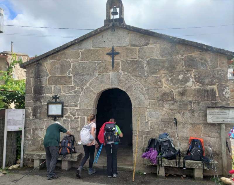 a picture of a group of pilgrims entering a church on the Camino