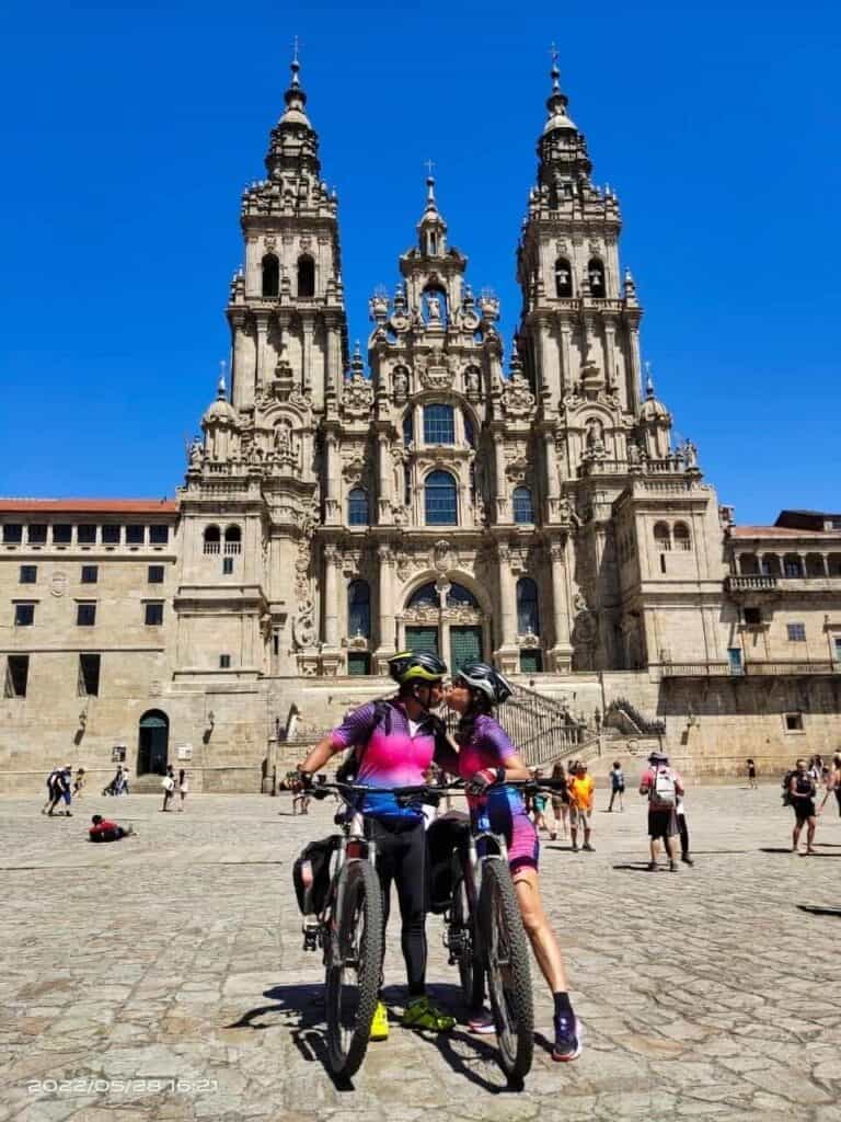 couple at santiago cathedral with bikes